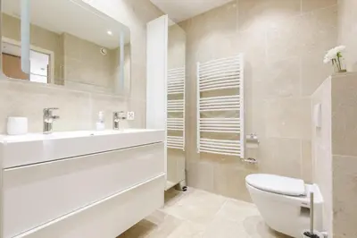 a white kitchen with a sink and a microwave at Carlton area XXL luxe 1 bed with large terrace in Cannes