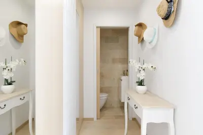 a bathroom with a sink and a toilet and a mirror at Carlton area XXL luxe 1 bed with large terrace in Cannes