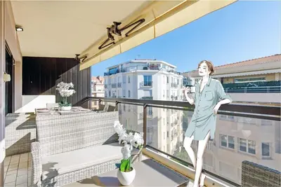 a white living room with white chairs and a kitchen at Carlton area XXL luxe 1 bed with large terrace in Cannes