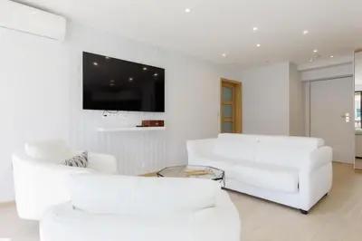 a patio with a table and chairs on a balcony at Carlton area XXL luxe 1 bed with large terrace in Cannes