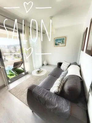 a living room with a couch and a sign that reads own at Cannes beach and Festival Palais in Cannes