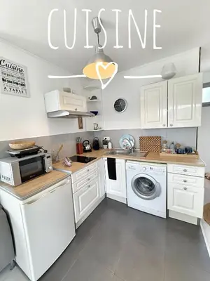 a kitchen with white cabinets and a washer and dryer at Cannes beach and Festival Palais in Cannes