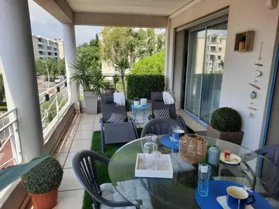 a patio with a table and chairs on a balcony at Cannes beach and Festival Palais in Cannes