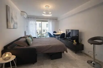a bedroom with a bed and a flat screen tv at Majestic in Cannes