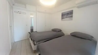 a bedroom with two beds and a hallway at Majestic in Cannes