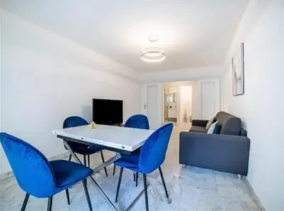 a dining room with blue chairs and a table at Majestic in Cannes