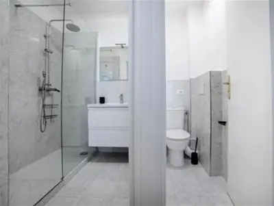 a bathroom with a glass shower and a toilet at Majestic in Cannes