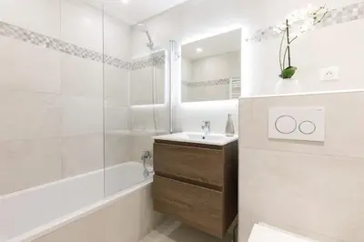 a white bathroom with a tub and a sink and a shower at On La Croisette deluxe 2 bedrooms 2 baths in Cannes