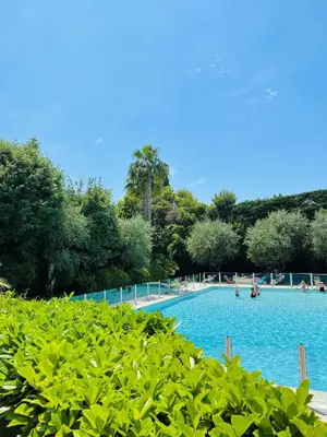 a large swimming pool with people in the water at Floriana in Cannes