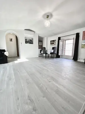 an empty living room with a table and chairs at Serbes Top Floor in Cannes