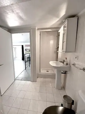a white bathroom with a sink and a shower at Serbes Top Floor in Cannes