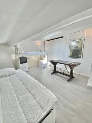 a bedroom with a bed and a desk in it at Serbes Top Floor in Cannes