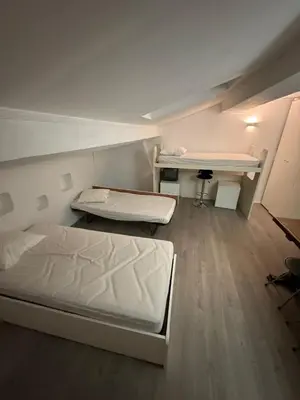 a large room with two beds and a desk at Serbes Top Floor in Cannes