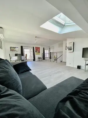 a living room with a couch and a skylight at Serbes Top Floor in Cannes