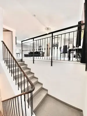 a staircase in a house with black railing at Serbes Top Floor in Cannes