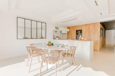 a kitchen with a white table and chairs at 4-Room Apartment of 96m with a Stunning View in Cannes