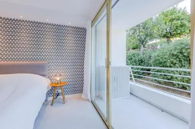 a bedroom with a bed and a large window at 4-Room Apartment of 96m with a Stunning View in Cannes