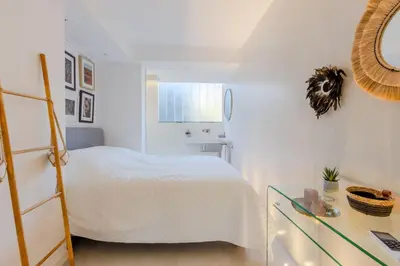a white bedroom with a bed and a desk at 4-Room Apartment of 96m with a Stunning View in Cannes