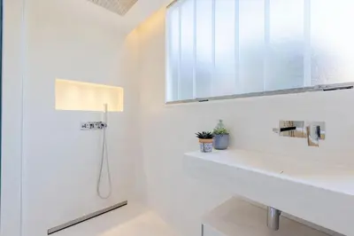 a white bathroom with a sink and a shower at 4-Room Apartment of 96m with a Stunning View in Cannes