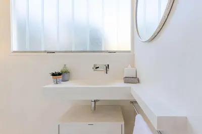 a bathroom with a sink and a mirror at 4-Room Apartment of 96m with a Stunning View in Cannes