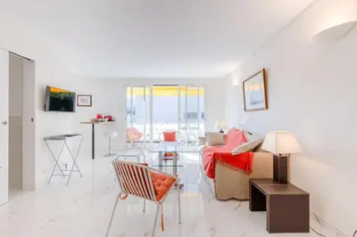 a living room with a couch and a table at Luxurious 2-room Apartment in Palm Beach in Cannes