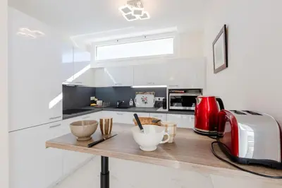 a kitchen with a counter with bowls and a toaster at Luxurious 2-room Apartment in Palm Beach in Cannes