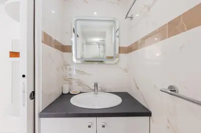 a bathroom with a sink and a mirror at Luxurious 2-room Apartment in Palm Beach in Cannes