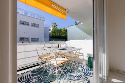 a patio with a table and chairs on a balcony at Luxurious 2-room Apartment in Palm Beach in Cannes