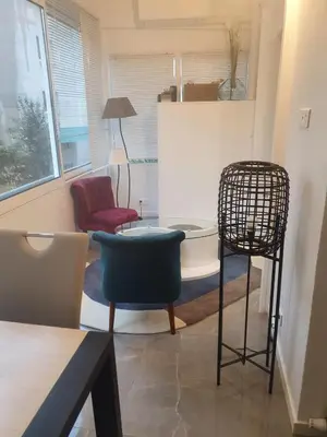 a living room with a chair and a table at Bel Apt Near Croisette Beach Cannes in Cannes