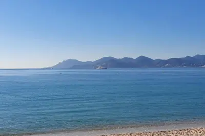a large body of water with mountains in the background at Bel Apt Near Croisette Beach Cannes in Cannes