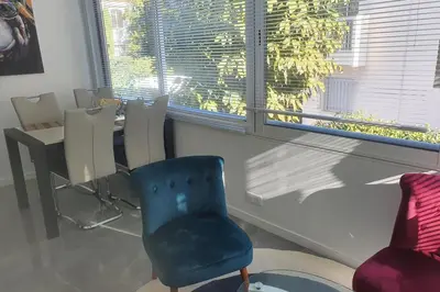 a living room with a blue chair and a table at Bel Apt Near Croisette Beach Cannes in Cannes