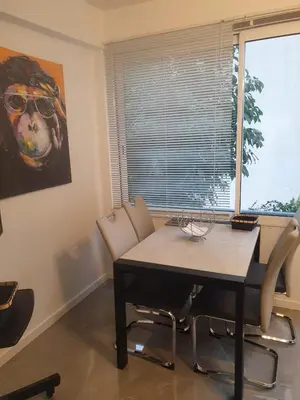 a dining room with a table and chairs and a window at Bel Apt Near Croisette Beach Cannes in Cannes