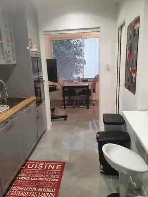 a kitchen with a table and a dining room at Bel Apt Near Croisette Beach Cannes in Cannes