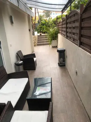 a balcony with couches and a table and stairs at STUDETTE Beausejour in Cannes