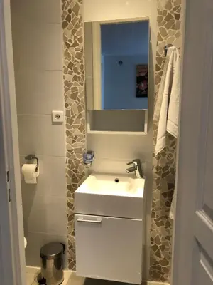 a bathroom with a white sink and a mirror at STUDETTE Beausejour in Cannes