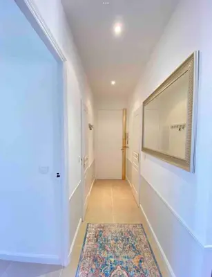 a hallway with a large mirror and a rug at Nice 2 bedrooms Meynadier at 2 min BeachPalais in Cannes