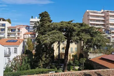 a tree in the middle of a city with buildings at Nice 2 bedrooms Meynadier at 2 min BeachPalais in Cannes