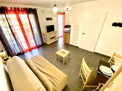 a living room with a couch and a table at Paul Doumer #2 By SCLS Locations in Le Cannet