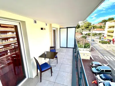 a balcony with a table and a view of a street at Paul Doumer #2 By SCLS Locations in Le Cannet