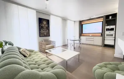 a living room with a couch and a television at Arundel Croisette 100m Beach, Palais Free Parking AC Fibre in Cannes