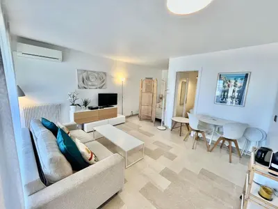 a living room with a couch and a table at Les jardins de la Croisette 6, by Welcome to Cannes in Cannes