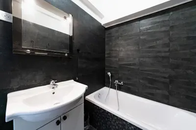 a bathroom with a white sink and a bath tub at Brand new 2 bedrooms heart of Cannes in Cannes