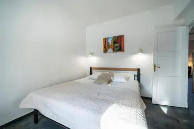 a bedroom with a white bed and a white door at Brand new 2 bedrooms heart of Cannes in Cannes