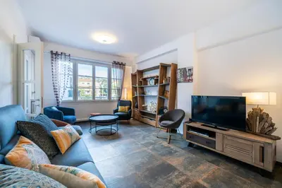 a living room with a couch and a flat screen tv at Brand new 2 bedrooms heart of Cannes in Cannes