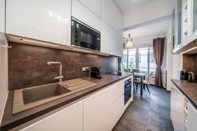a kitchen with white cabinets and a sink at Brand new 2 bedrooms heart of Cannes in Cannes