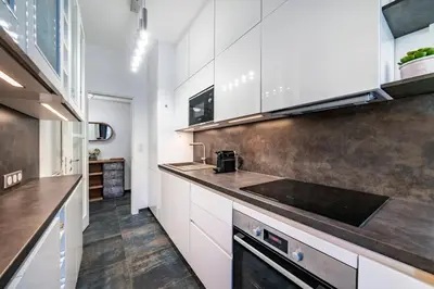 a kitchen with white cabinets and a sink at Brand new 2 bedrooms heart of Cannes in Cannes