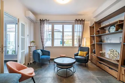 a living room with chairs and a table at Brand new 2 bedrooms heart of Cannes in Cannes