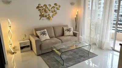 a living room with a couch and a glass table at 1 mn CROISETTE près Martinez in Cannes