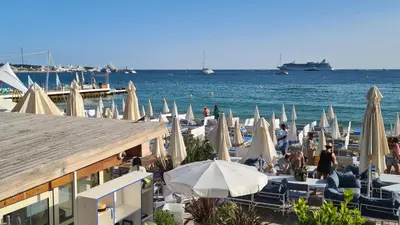 a group of umbrellas and chairs on a beach at 1 mn CROISETTE près Martinez in Cannes