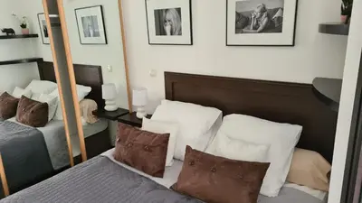 a bedroom with a mirror and a bed with pillows at 1 mn CROISETTE près Martinez in Cannes